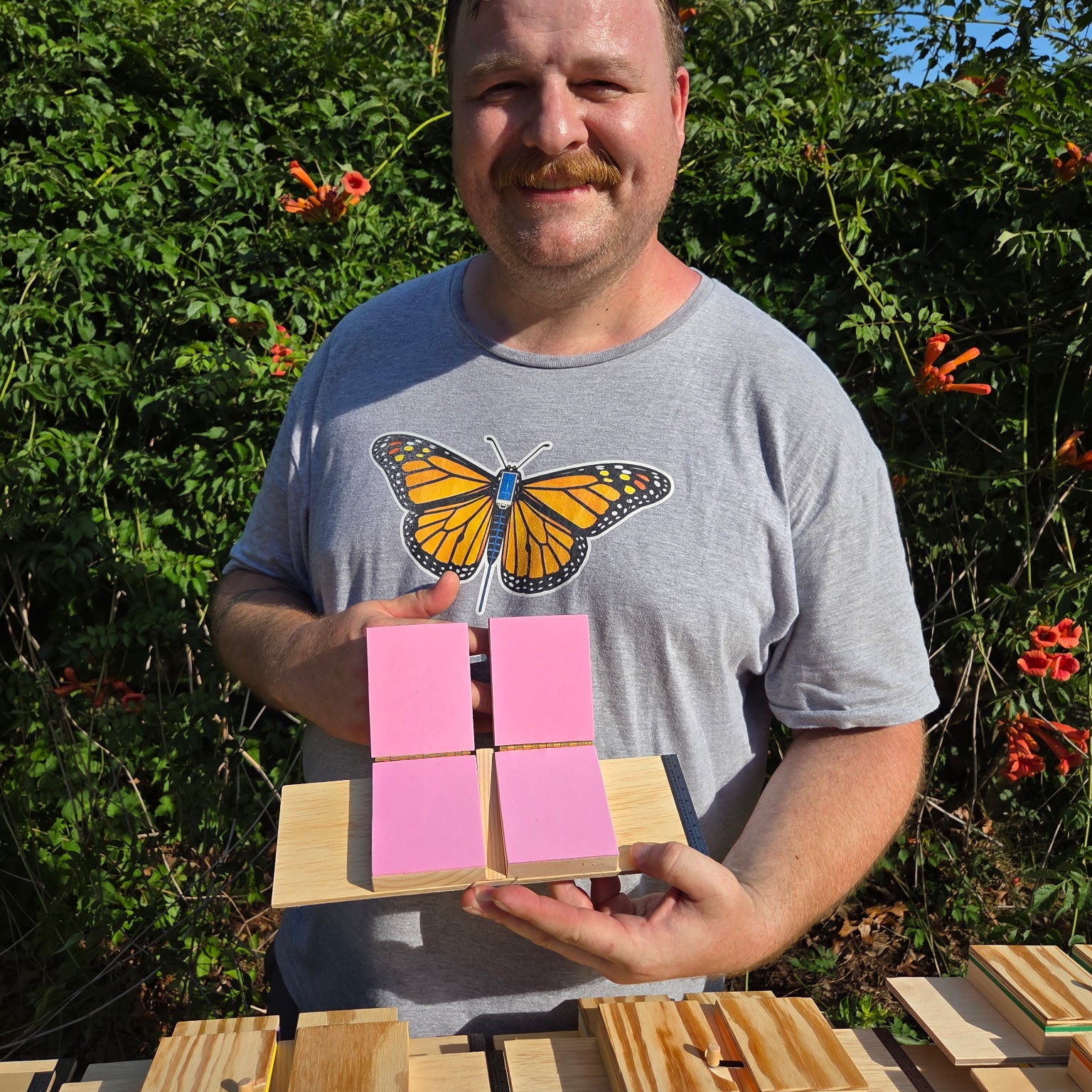 Don Crawford demonstrating vinyl cleanup stickers on a monarch tagging board