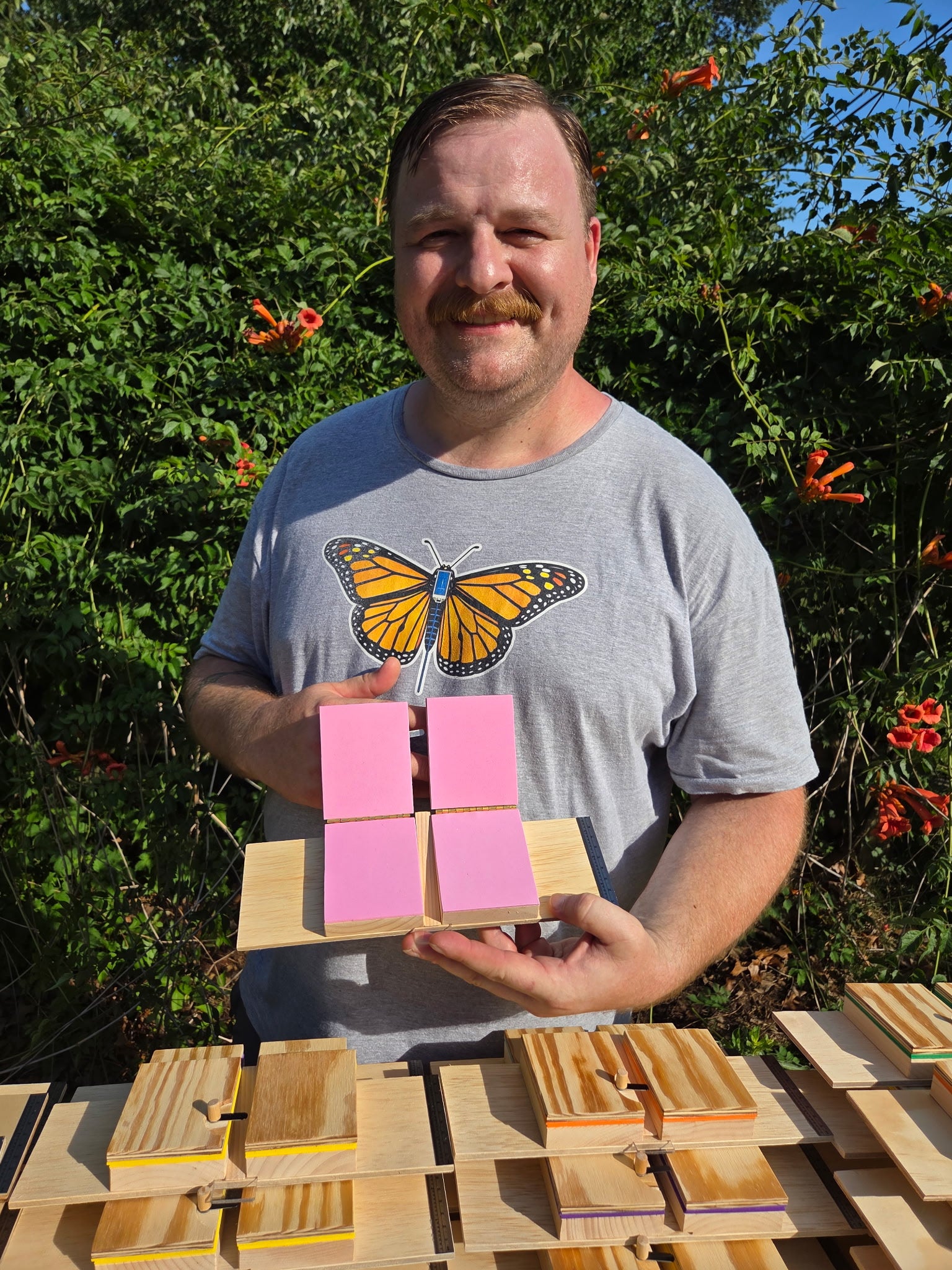 Don Crawford demonstrating vinyl cleanup stickers on a monarch tagging board