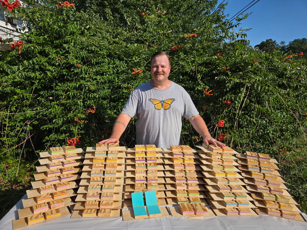 Don Crawford with handcrafted monarch tagging boards in assorted accent colors